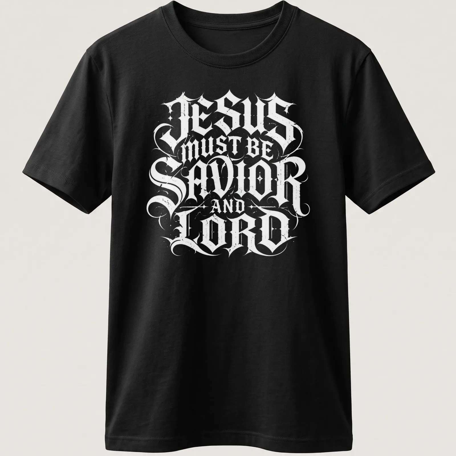 Ornate lettering of 'Jesus Must Be Savior And Lord' in black and white — printed on a unisex t-shirt