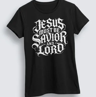 Ornate lettering of 'Jesus Must Be Savior And Lord' in black and white — printed on a women's shirt