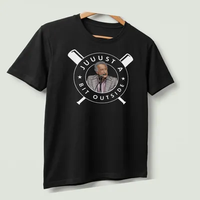 Cartoon of a man at a microphone in gray, light pink, black, and white colors — printed on a unisex t-shirt (angled view)