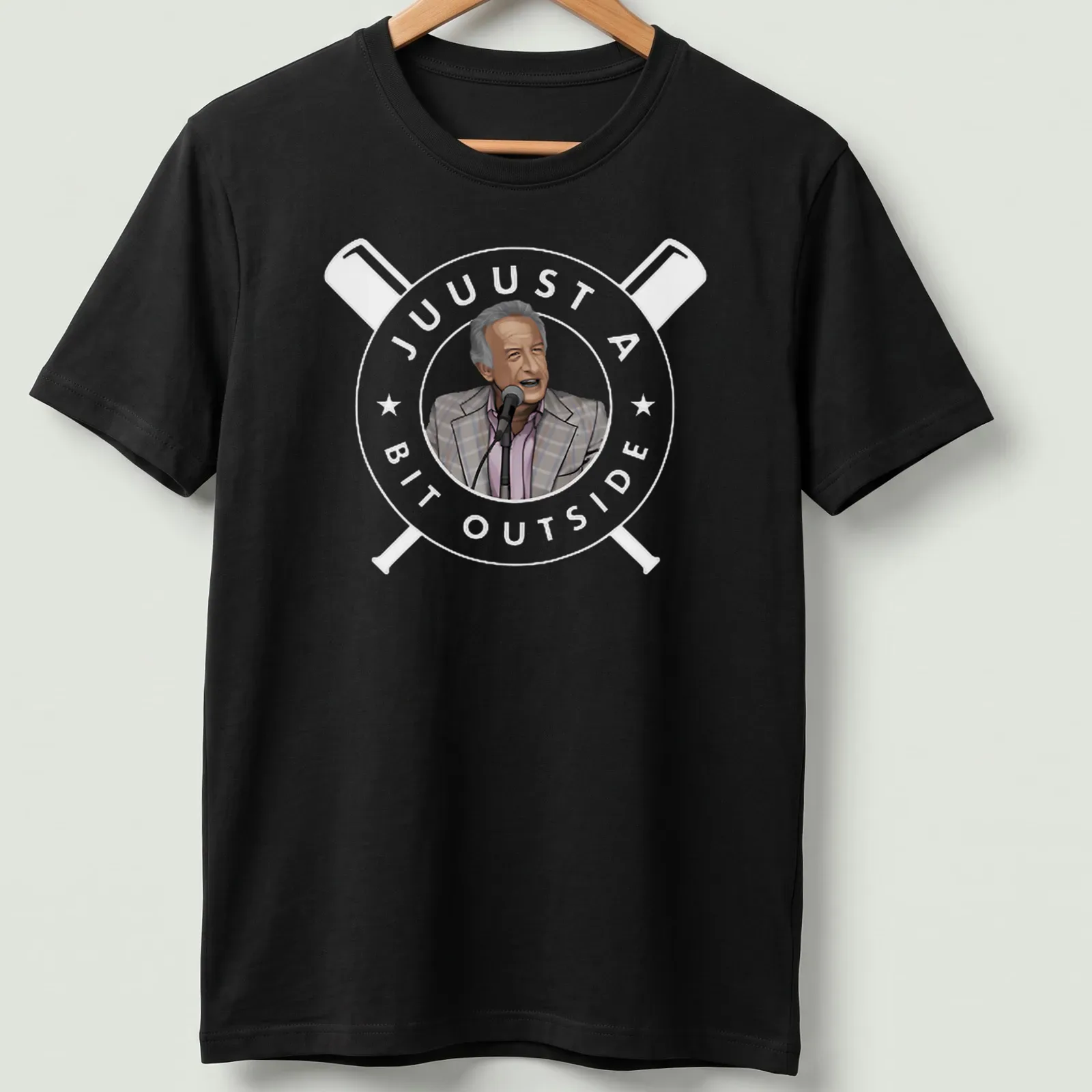 Cartoon of a man at a microphone in gray, light pink, black, and white colors — printed on a unisex t-shirt
