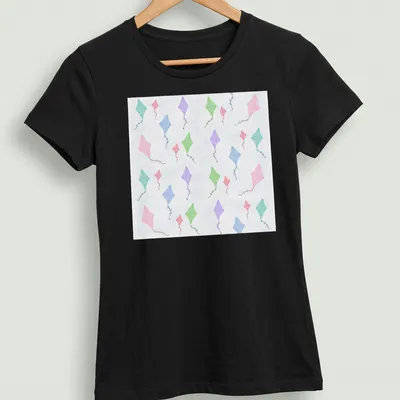 Watercolor design of colorful kites against a light blue sky — printed on a women's shirt