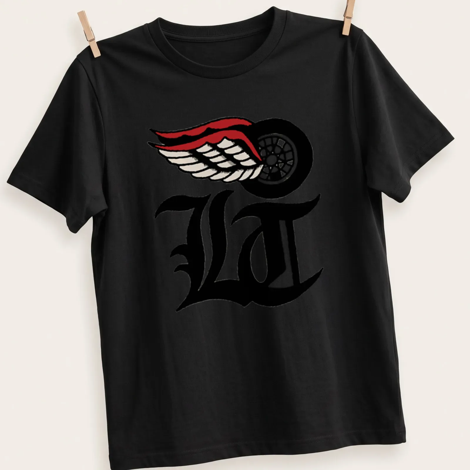 Bold LA logo with wings in black, white, red, and cream — printed on a unisex t-shirt