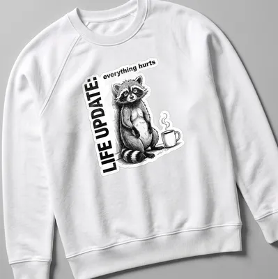 Vintage illustration of a raccoon with text reading Life Update: everything hurts in black, white, and gray — printed on a unisex sweatshirt