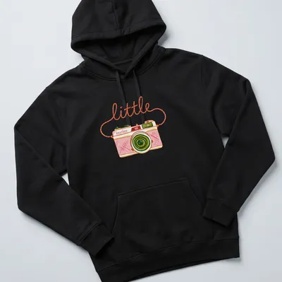 Watercolor design of a camera with the text 'little kaydee' in pink and green hues — printed on a unisex hoodie