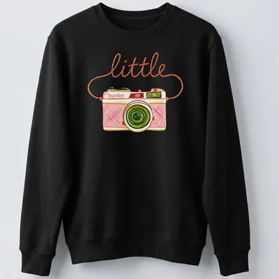 Watercolor design of a camera with the text 'little kaydee' in pink and green hues — printed on a unisex sweatshirt