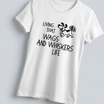 Playful line-art of a cartoon dog with the phrase 'Living That Wags And Whiskers Life' below — printed on a women's shirt