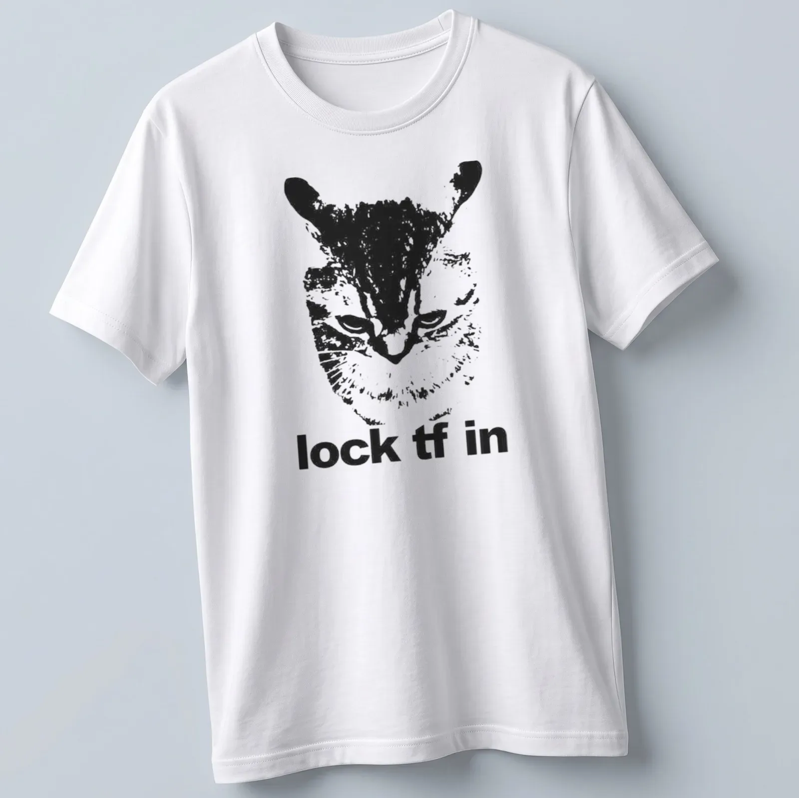 Bold monochrome t-shirt featuring a playful cat and the text 'lock tf in' — printed on a unisex t-shirt