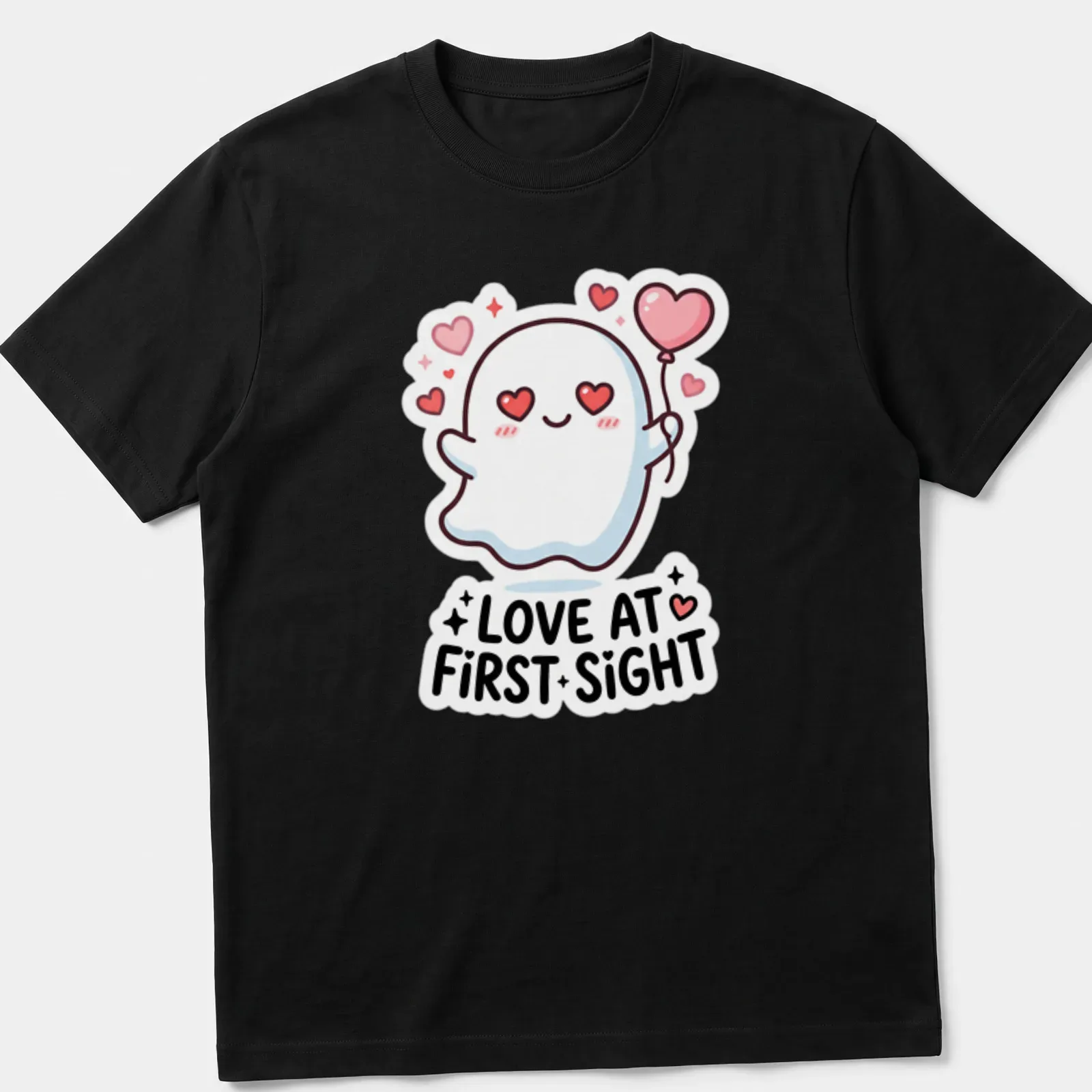 Kawaii ghost holding a heart balloon with Love At First Sight text in pink and black — printed on a unisex t-shirt