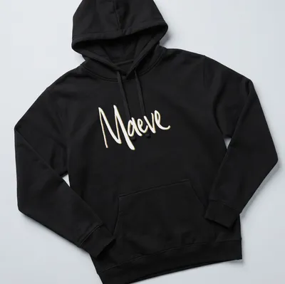Personalized Maeve t-shirt with elegant gold script on white background — printed on a unisex hoodie