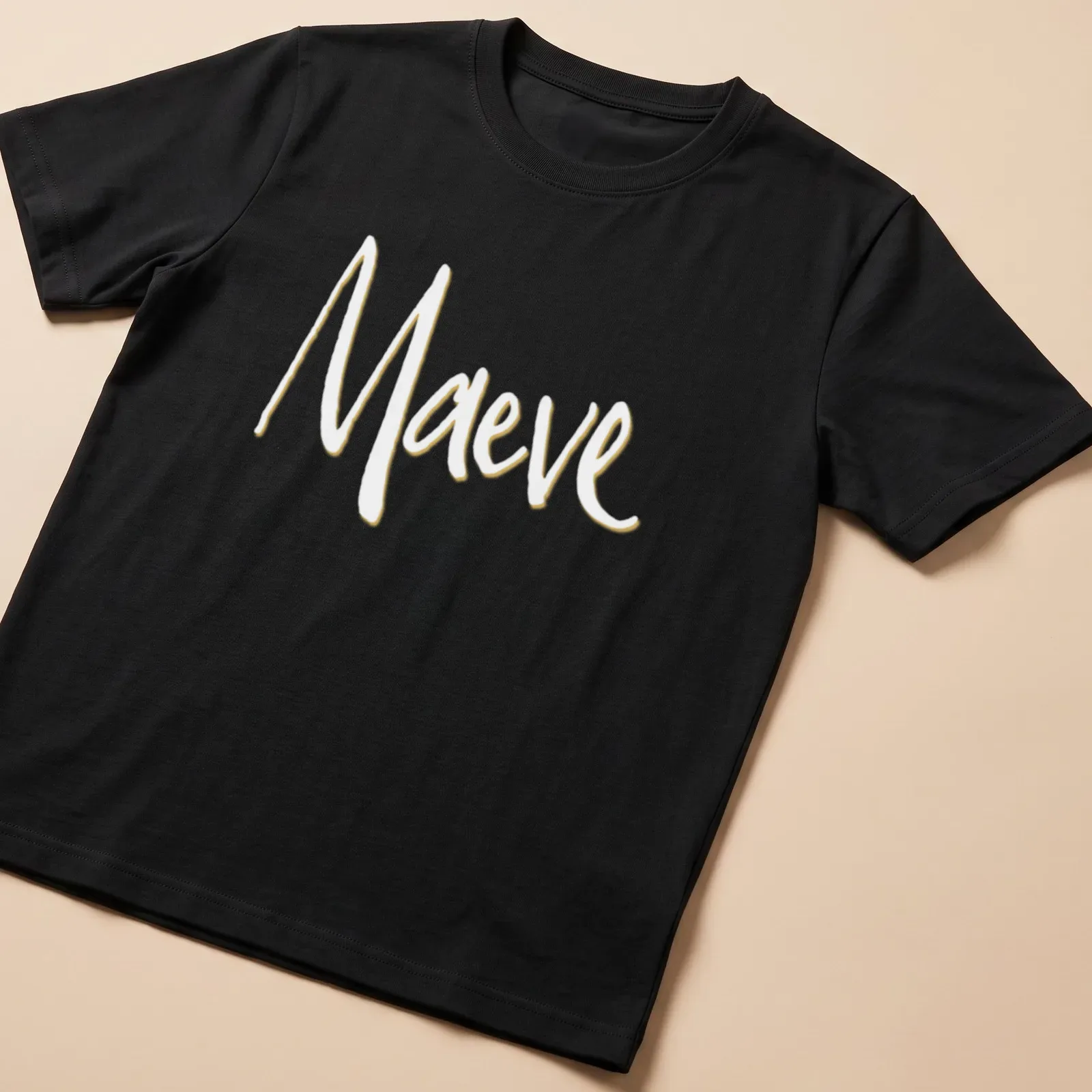 Personalized Maeve t-shirt with elegant gold script on white background — printed on a unisex t-shirt