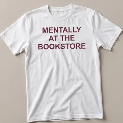 Bold typography t-shirt with the text 'Mentally At The Bookstore' in maroon and white