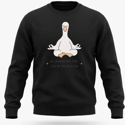 Kawaii line-art of a meditating goose with the phrase about chakras above it. — printed on a unisex sweatshirt