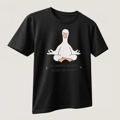 Kawaii line-art of a meditating goose with the phrase about chakras above it. — printed on a unisex t-shirt (angled view)