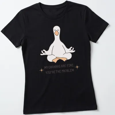 Kawaii line-art of a meditating goose with the phrase about chakras above it. — printed on a women's shirt
