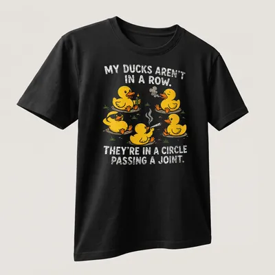Funny cartoon shirt with yellow ducks and humorous text about ducks passing a joint — printed on a unisex t-shirt (angled view)