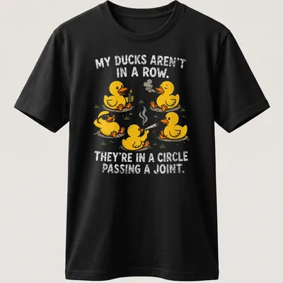 Funny cartoon shirt with yellow ducks and humorous text about ducks passing a joint