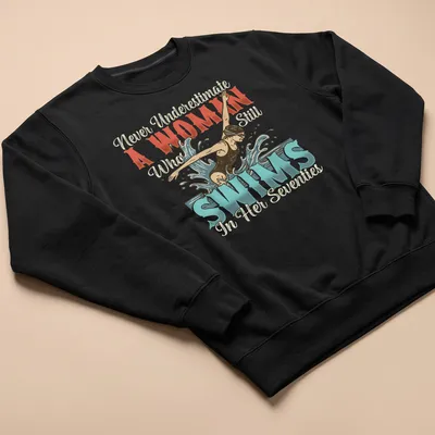 Vintage illustration of a swimmer with empowering text in blue, red, cream, and black — printed on a unisex sweatshirt