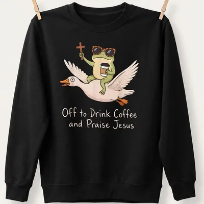 Cartoon frog riding a goose, with the phrase Off to Drink Coffee and Praise Jesus printed above. — printed on a unisex sweatshirt