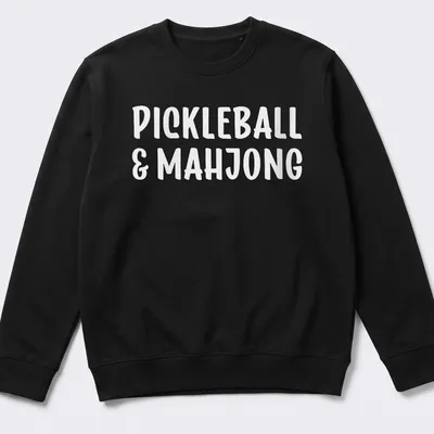 Bold typography design featuring pickleball and mahjong text in white — printed on a unisex sweatshirt
