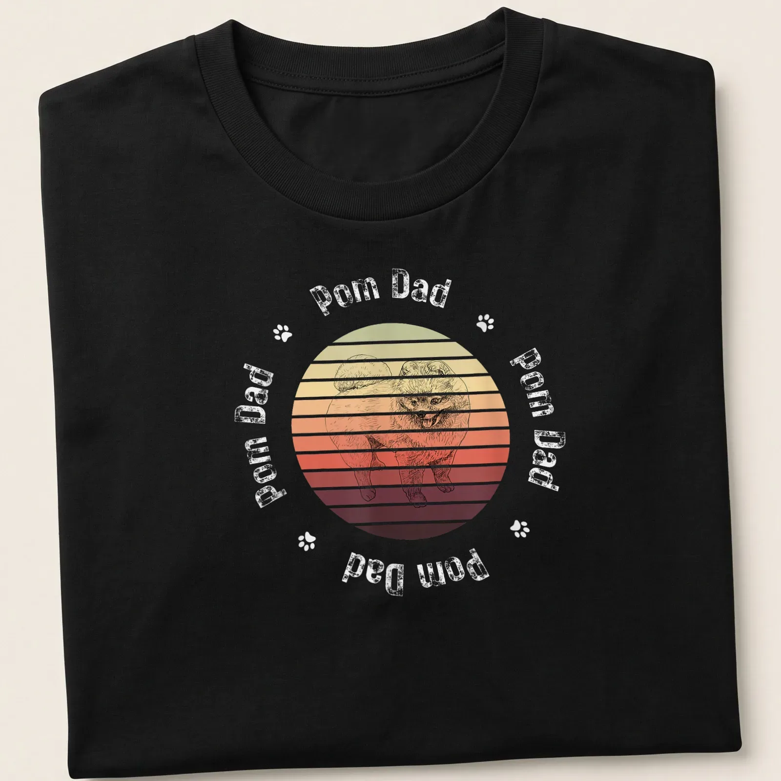 Retro sunset design featuring a cheerful Pomeranian with Pom Dad text — printed on a unisex t-shirt