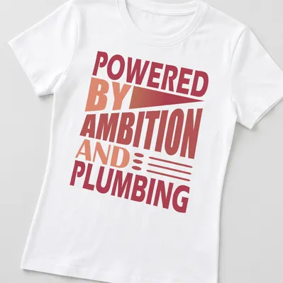 Bold typography t-shirt with the phrase 'Powered By Ambition And Plumbing' in red and orange. — printed on a women's shirt