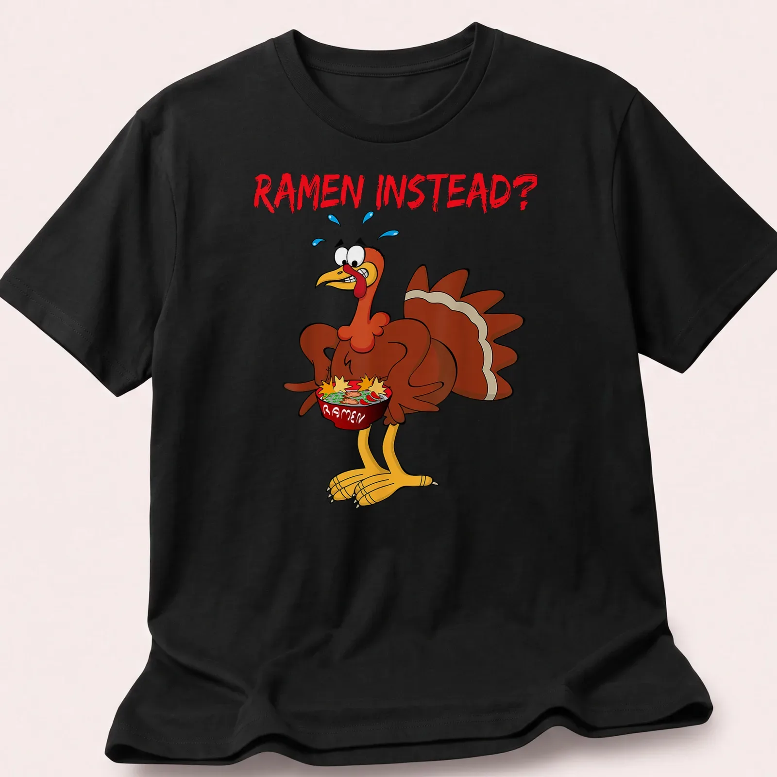 Cartoon turkey holding a ramen bowl with the text 'RAMEN INSTEAD?' — printed on a unisex t-shirt