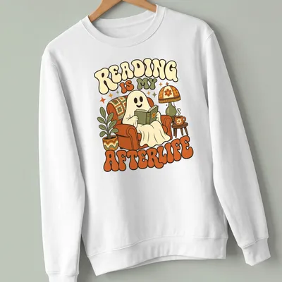 Retro-style T-shirt featuring a ghost reading a book with colorful text — printed on a unisex sweatshirt