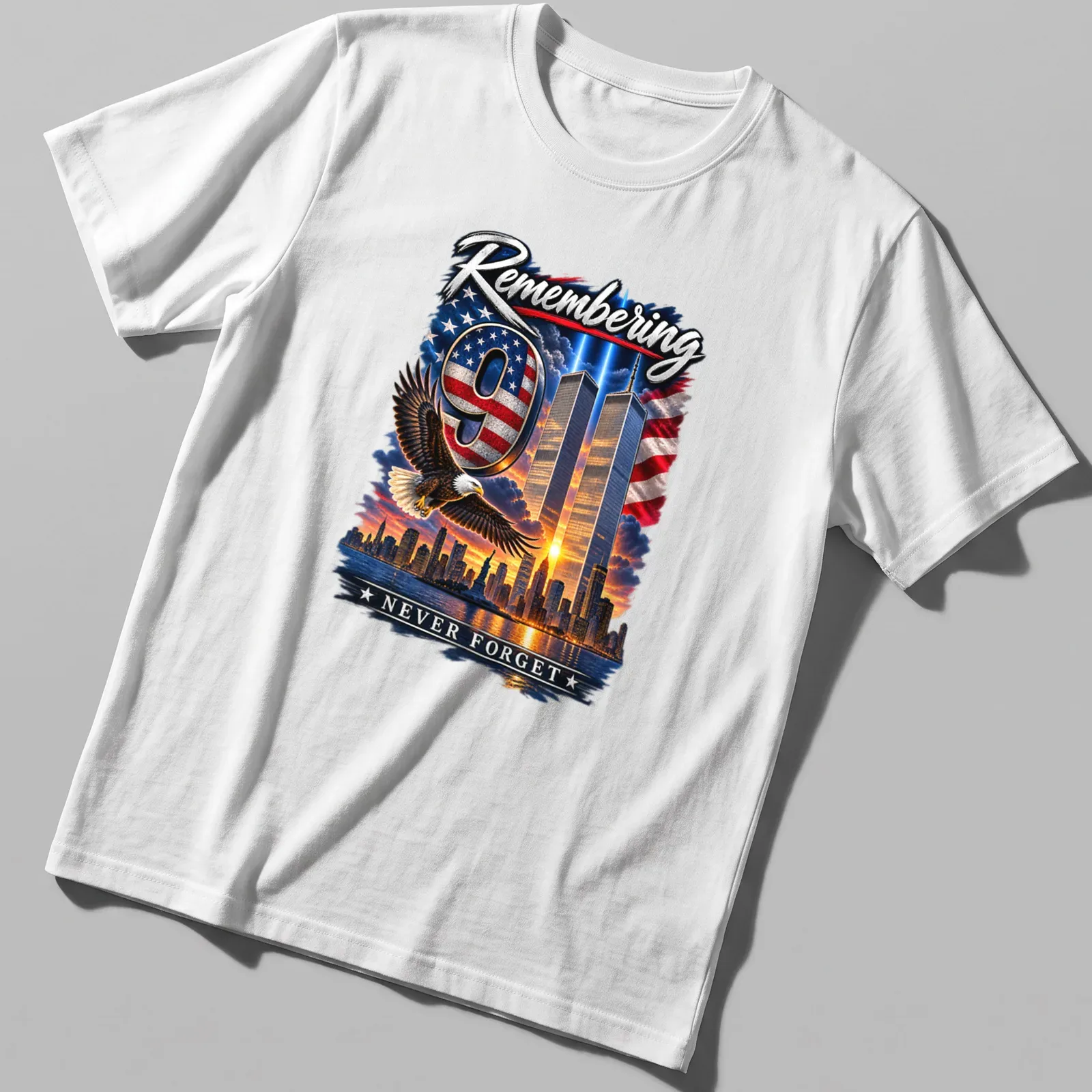 Eagle flying over Twin Towers with the text 'Remembering 9 NEVER FORGET' in patriotic colors — printed on a unisex t-shirt