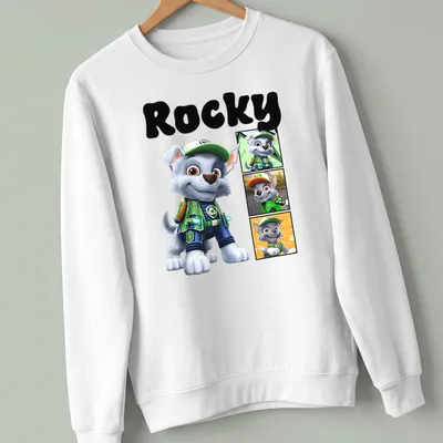 Cartoon design of Rocky from Paw Patrol in gray, green, blue, and orange — printed on a unisex sweatshirt