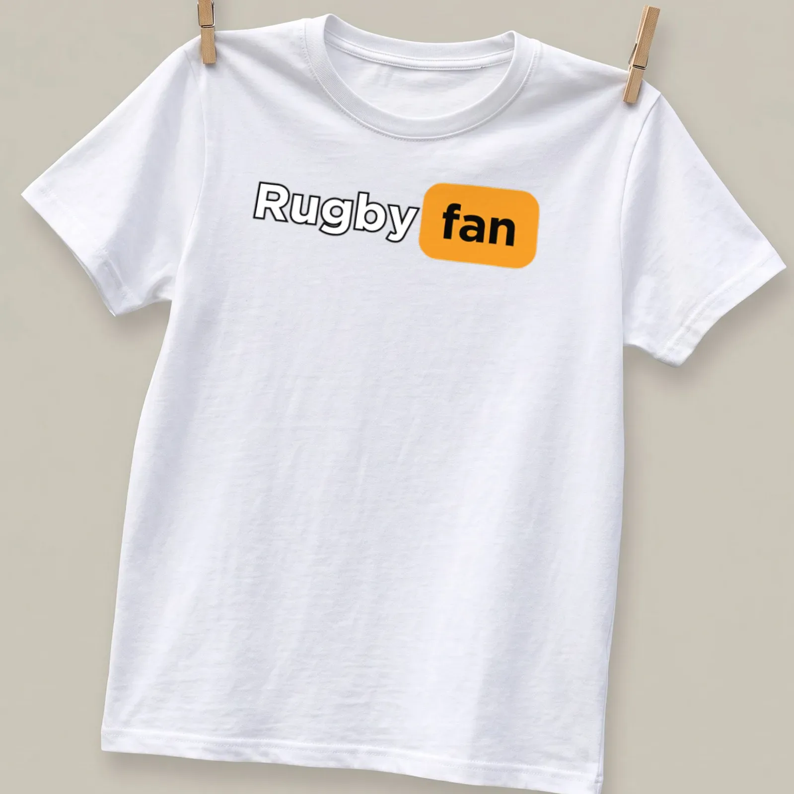 Bold modern Rugby Fan t-shirt featuring black, orange, and white text — printed on a unisex t-shirt