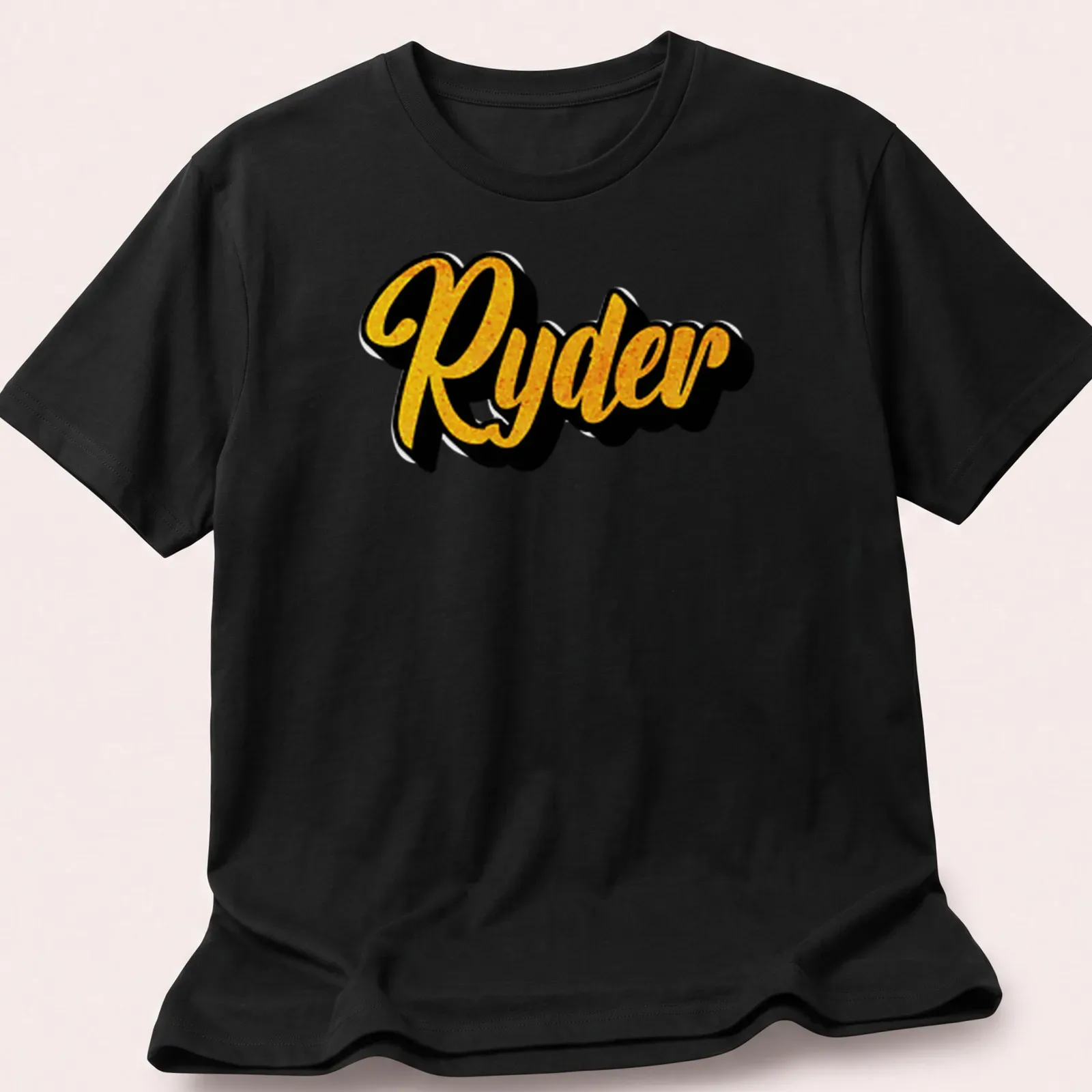 Personalized boys T-shirt with bold yellow script reading 'Ryder' on black — printed on a unisex t-shirt