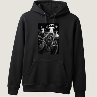 Realistic black and white print of Sasquatch taking a selfie with UFOs — printed on a unisex hoodie