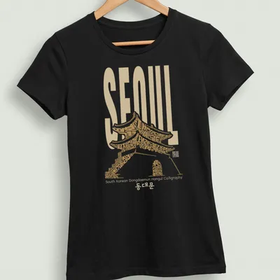 T-shirt featuring Hangul calligraphy of 'SEOUL South Korean Dongdaemun' with traditional architecture styling — printed on a women's shirt