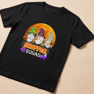 Cartoon Halloween gnomes with the text 'SHOPPER SQUAD' in playful font. — printed on a unisex t-shirt