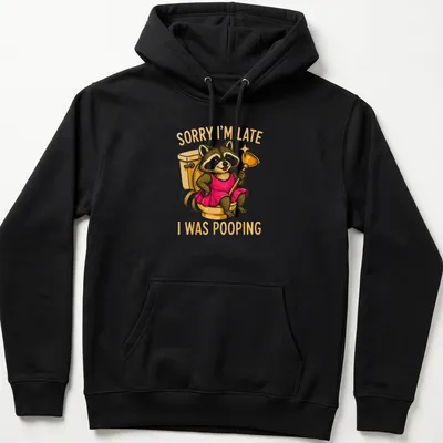 Cartoon raccoon in a dress with humorous text about being late due to pooping — printed on a unisex hoodie