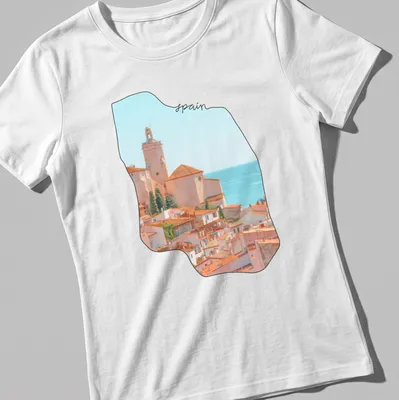 Watercolor coastal village scene with 'spain' text in soft colors — printed on a women's shirt