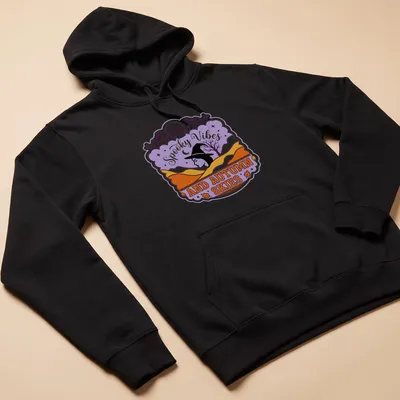 Vintage style T-shirt featuring witch silhouette and spooky vibes text in purple, orange, and black — printed on a unisex hoodie