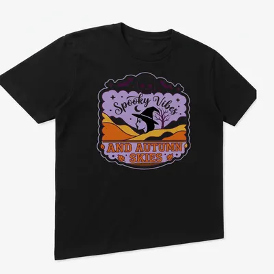 Vintage style T-shirt featuring witch silhouette and spooky vibes text in purple, orange, and black — printed on a unisex t-shirt (angled view)