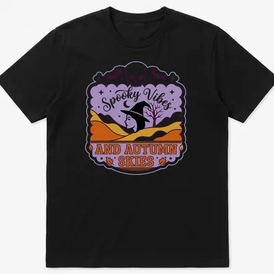 Vintage style T-shirt featuring witch silhouette and spooky vibes text in purple, orange, and black