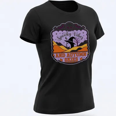 Vintage style T-shirt featuring witch silhouette and spooky vibes text in purple, orange, and black — printed on a women's shirt