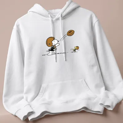 Cartoon Snoopy character playing football with Pittsburgh Steelers text above — printed on a unisex hoodie