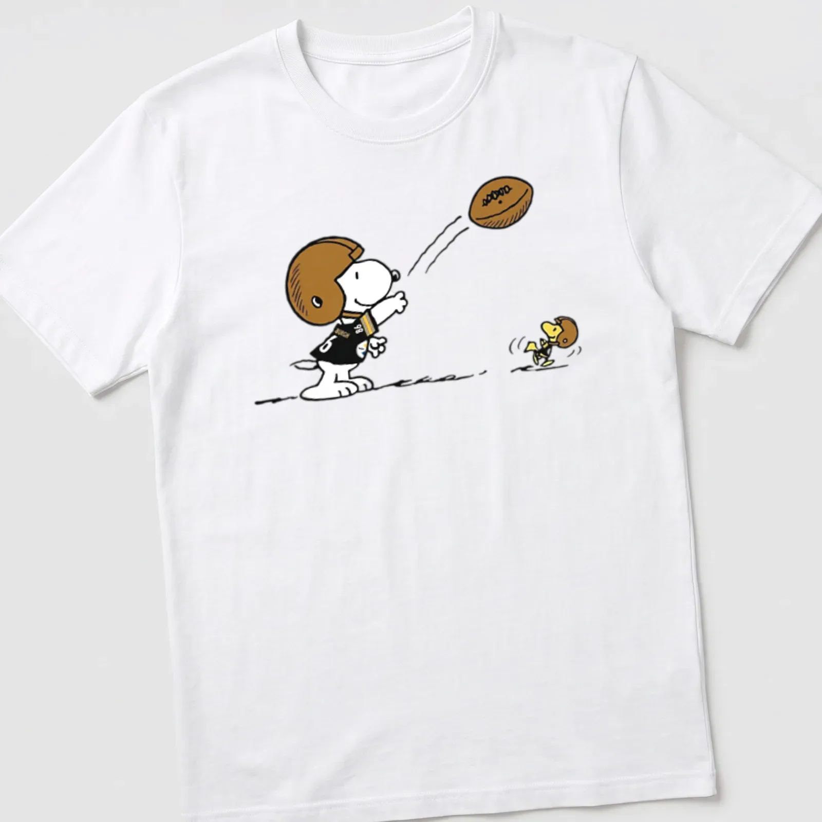 Cartoon Snoopy character playing football with Pittsburgh Steelers text above — printed on a unisex t-shirt