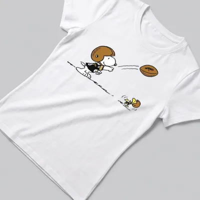 Cartoon Snoopy character playing football with Pittsburgh Steelers text above — printed on a women's shirt