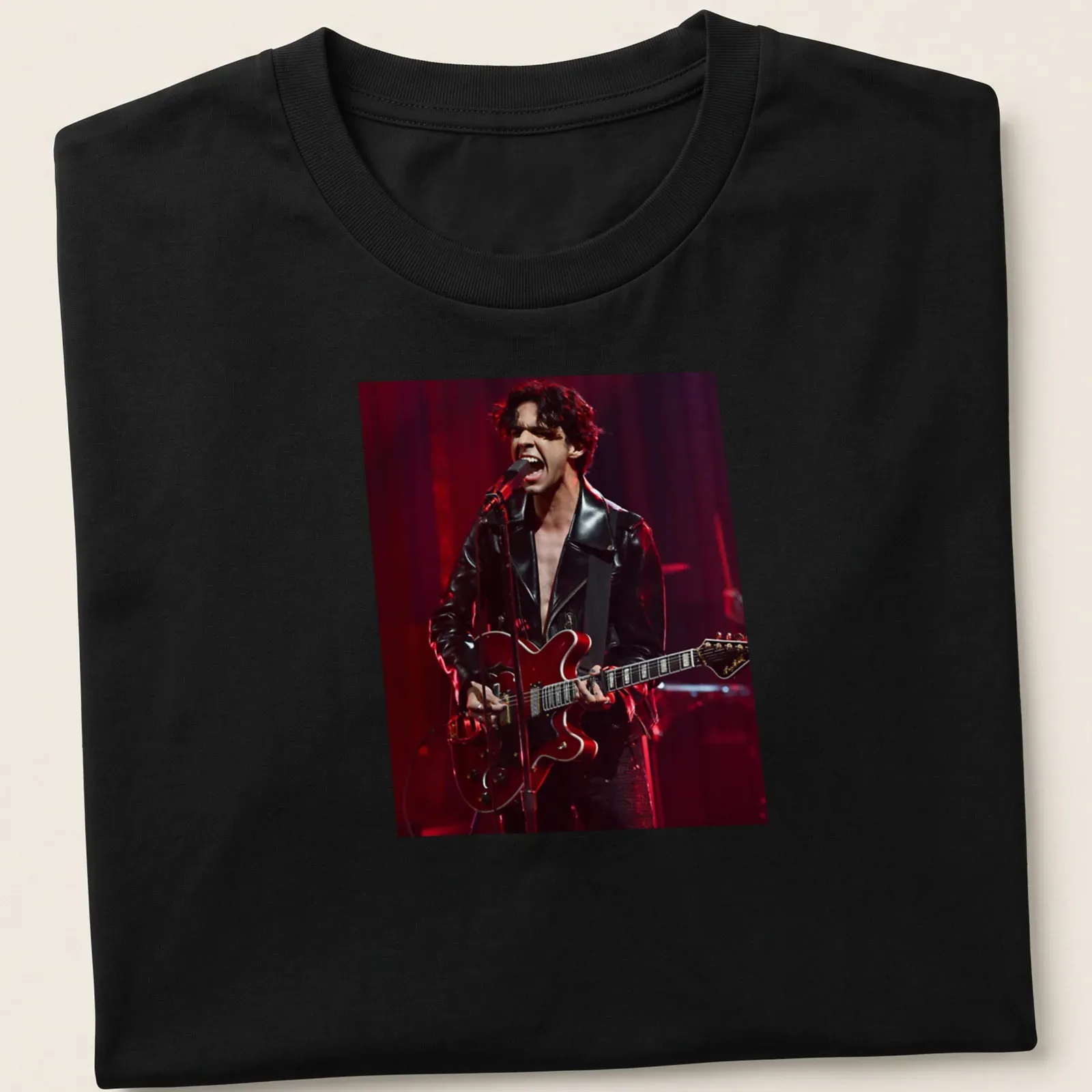 Illustration of a musician with a guitar in black, red, and grey. — printed on a unisex t-shirt