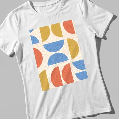 Modern geometric semicircles in cream, blue, red, and gold on — printed on a women's shirt