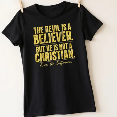 Bold typography t-shirt with the phrase about the devil's beliefs in yellow and white — printed on a women's shirt