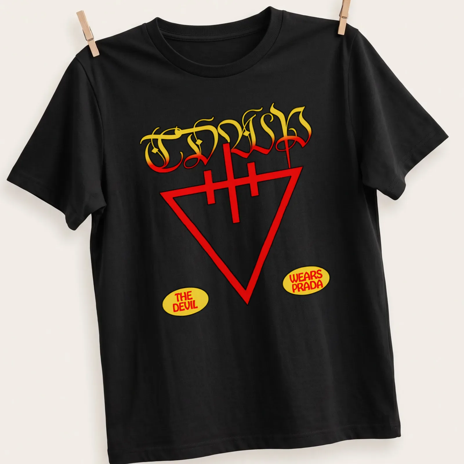 Vintage t-shirt featuring a stylized devil graphic and text 'The Devil Wears Prada' in red and yellow — printed on a unisex t-shirt