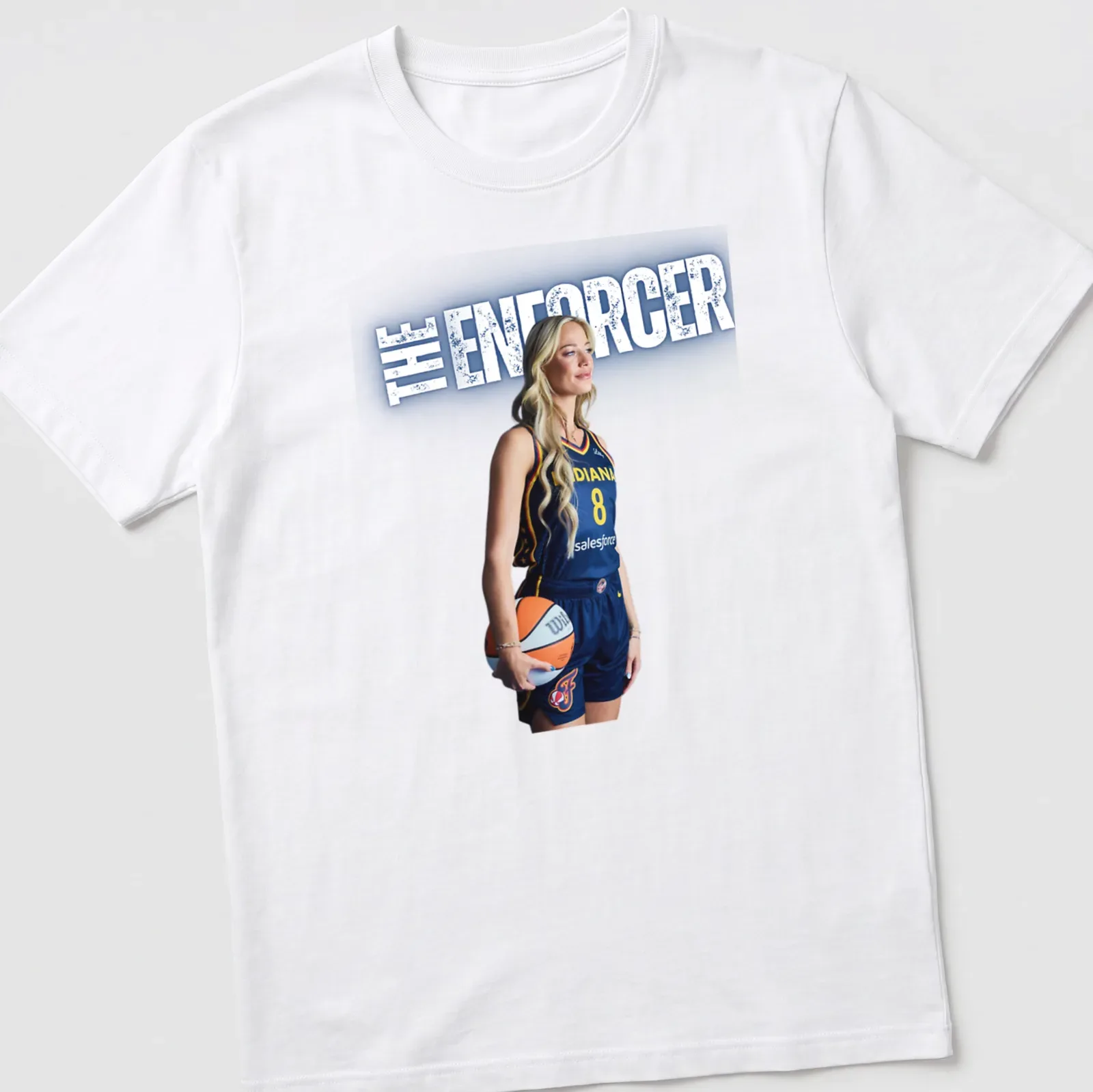 Illustration of a basketball player with 'THE ENFORCER' text in navy, yellow, and white. — printed on a unisex t-shirt