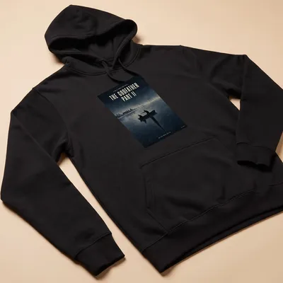 Minimal illustration of silhouetted figures in a boat, with text from The Godfather Part II — printed on a unisex hoodie
