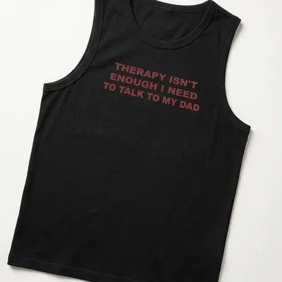 Bold typography shirt stating 'THERAPY ISN'T ENOUGH I NEED TO TALK TO MY DAD' in red on white. — printed on a tank top